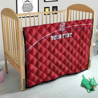 Red quilted football blanket on toddler bed with Liberia crest and 'YOUR TEXT'.