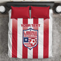 Red and white striped bedding set with two red pillows and Liberia Football crest
