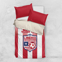 Red and white striped bedding set with red pillowcases and Liberia Football crest panel