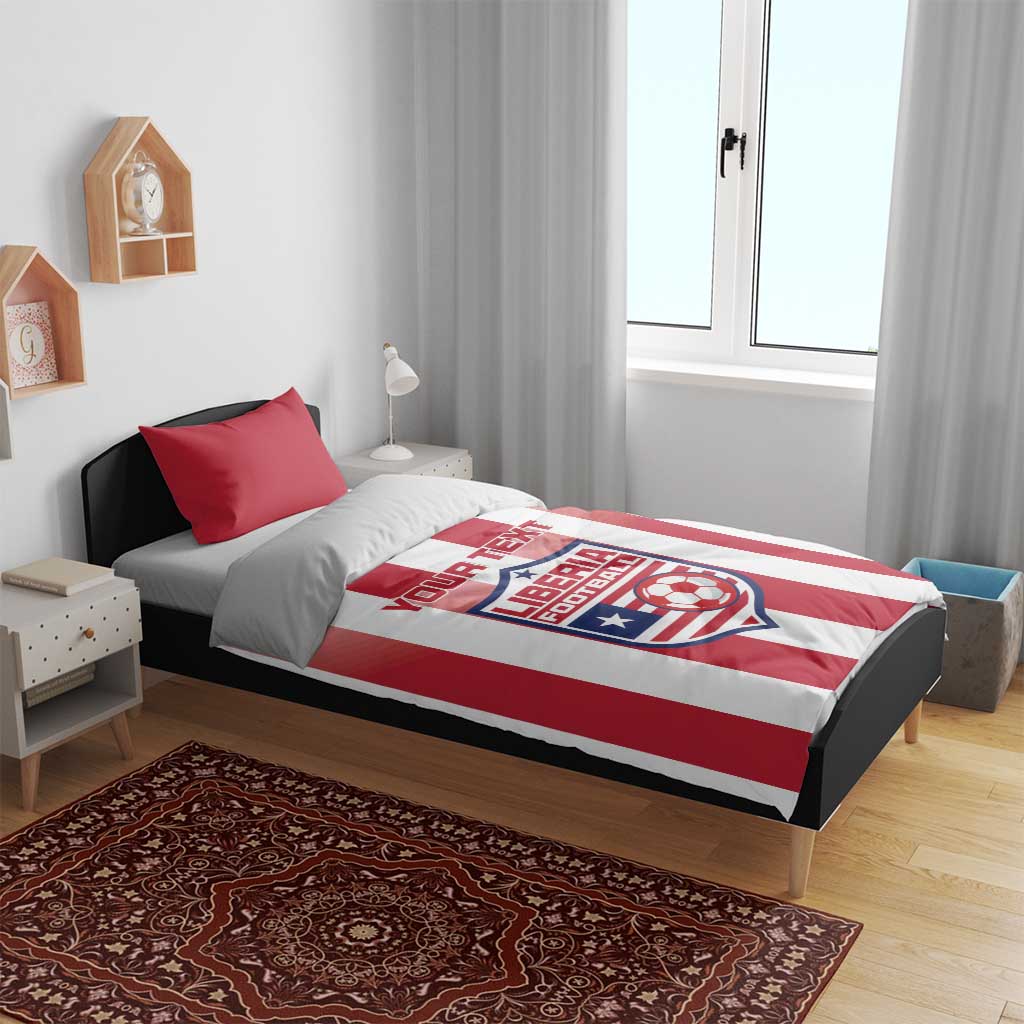 Red and white striped bedding set on bed with Liberia Football logo on duvet