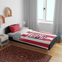 Red and white striped bedding set on bed with Liberia Football logo on duvet