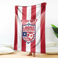 Red-and-white striped football blanket with Liberia crest and custom text, hanging