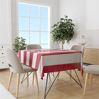 Red and white striped football tablecloth covering rectangular table, crest centered.