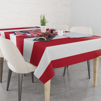 Red and white striped football tablecloth with crest on tabletop, draped edges.