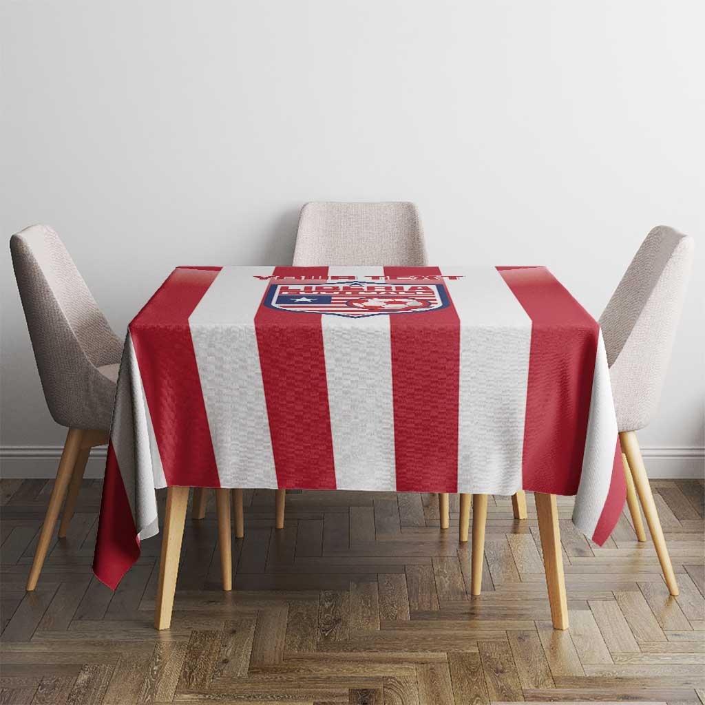 Red and white striped football tablecloth with crest panel on dining table surface.