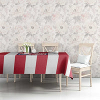 Red and white striped football tablecloth with centered Liberia crest on dining table.
