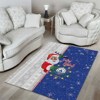 Blue Christmas area rug showing Santa in red with star and snow motifs, on gray stripes