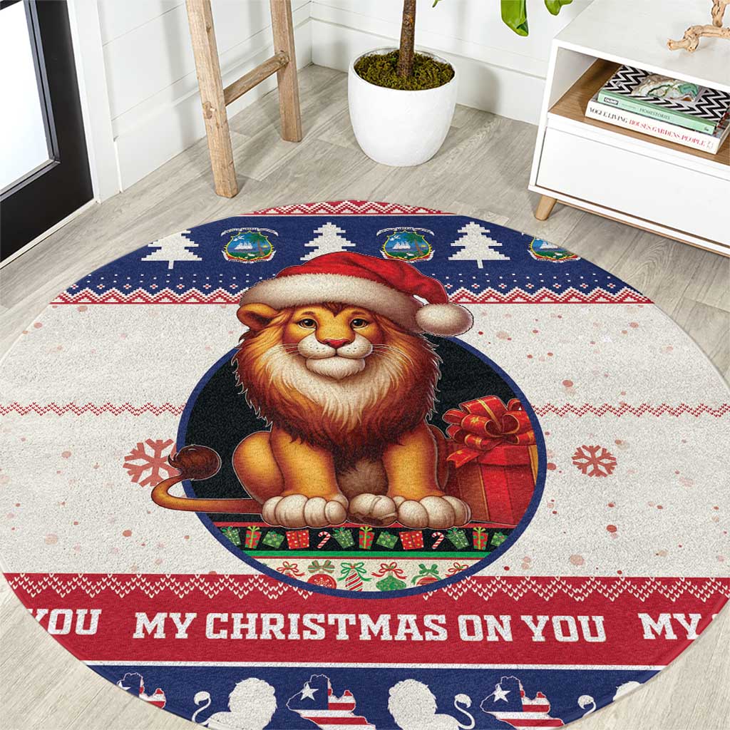 Round Christmas rug with lion Santa graphic, red hat and gift on blue border