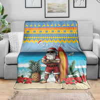 Blue Christmas blanket draped over sofa, surfer Santa with surfboard and tropical plants