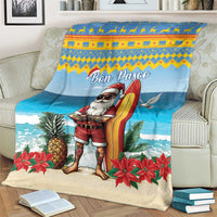 Blue Christmas blanket on couch with surfer Santa, surfboard, ocean waves, pineapples