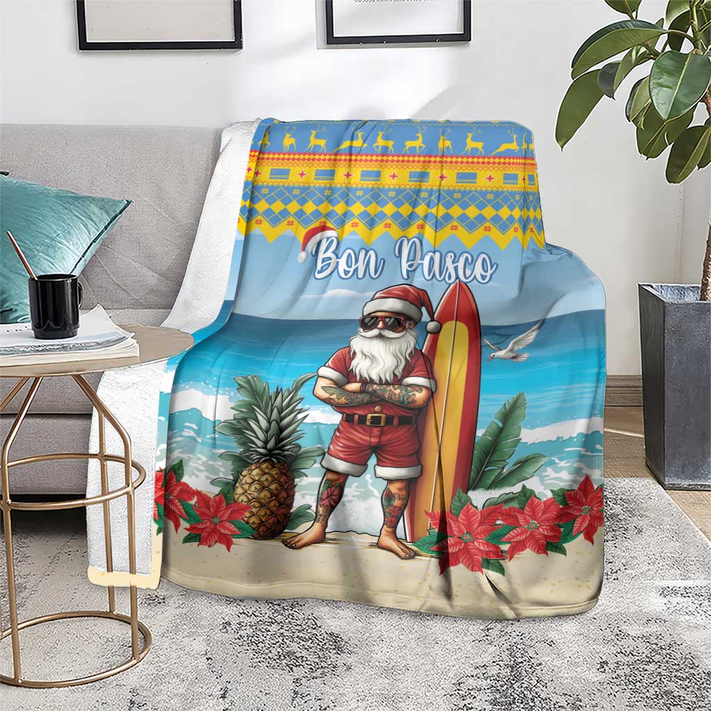Blue Christmas blanket on floor over throws, surfer Santa with surfboard and poinsettias
