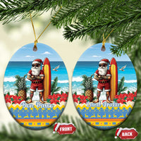 Two blue round ceramic ornaments with Santa surfing; “Bon Pasco” and “Land Aruba” text.