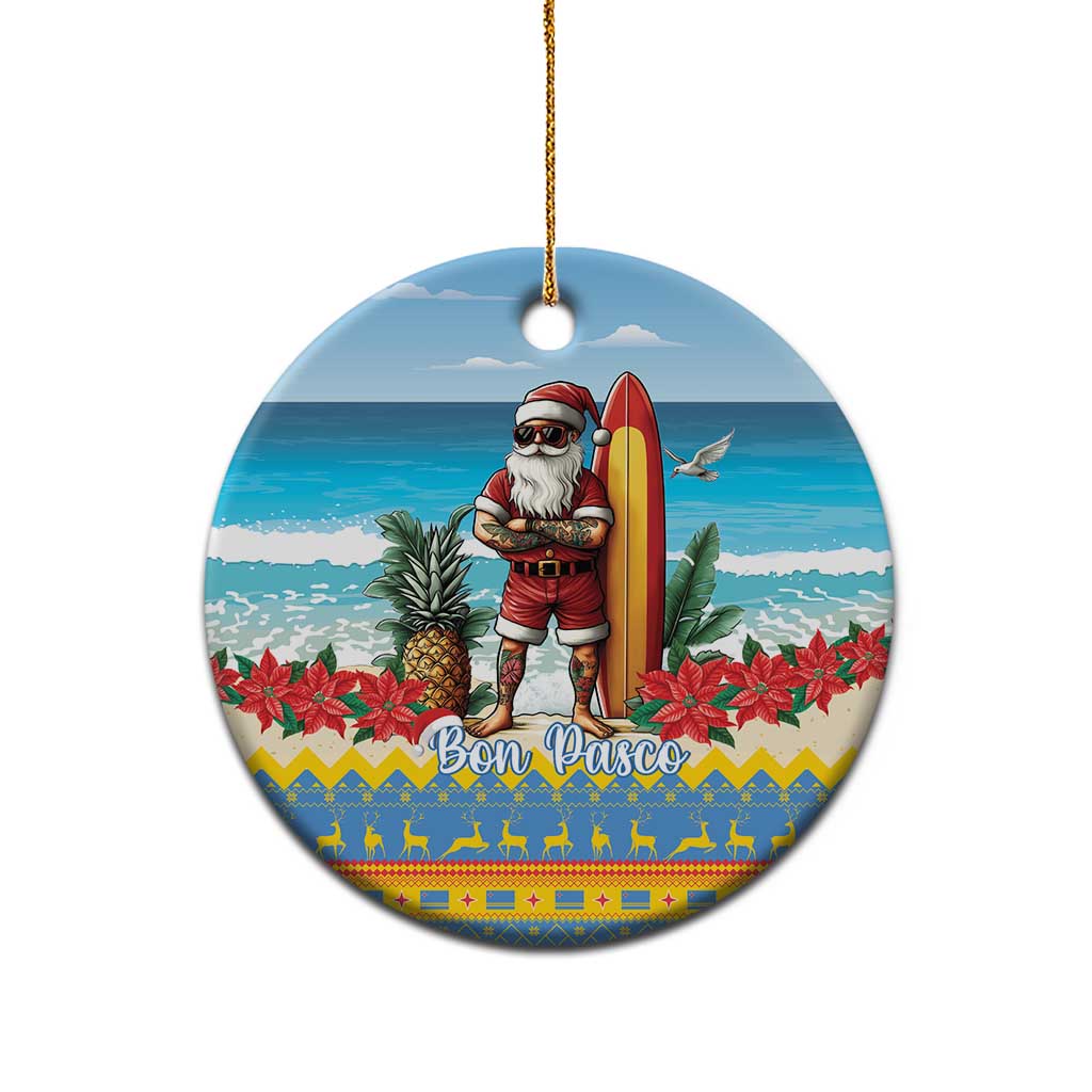 Blue round ceramic Christmas ornament featuring Santa surfing on a tropical beach scene.