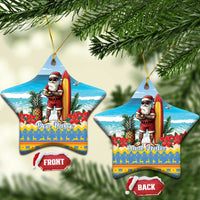 Two blue star-shaped ceramic ornaments with Santa surfing and “Bon Pasco/Land Aruba” lettering.