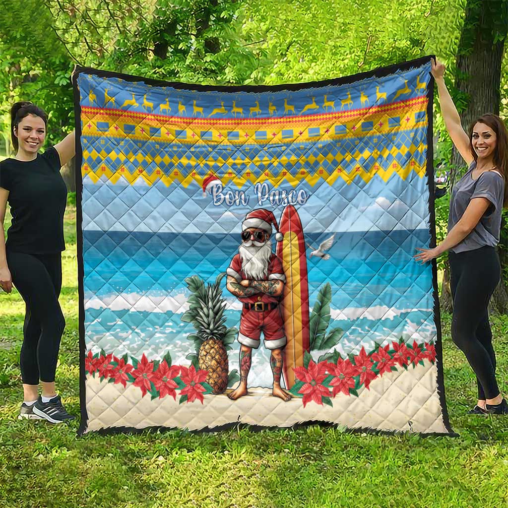 Blue quilt featuring a surfing Santa, pineapples and red poinsettias with “Bon Pasco”