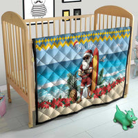 Blue crib quilt with surfing Santa, “Bon Pasco” text, pineapple and red poinsettias
