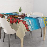 Christmas tablecloth with blue ocean wave section and red poinsettia leaves
