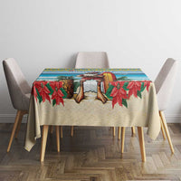 Christmas tablecloth featuring a surf scene with Santa and red poinsettia leaves