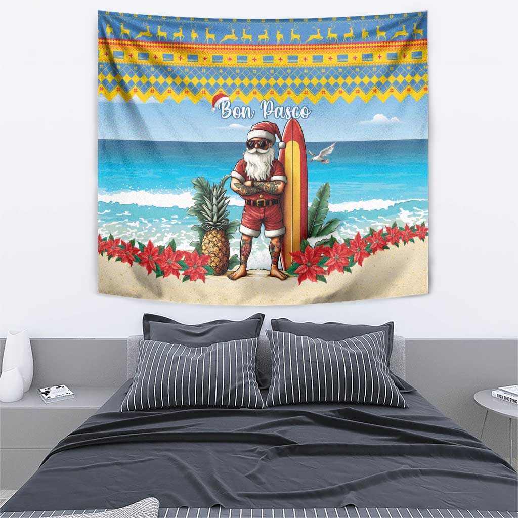 Christmas beach wall tapestry with Santa in red holding a surfboard over a sandy seaside scene.