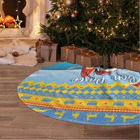Blue round Christmas tree skirt with surfing Santa and 'Bon Pasco' graphic, blue-yellow pattern