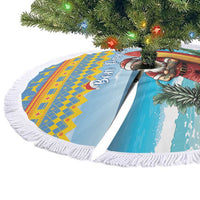 Blue round Christmas tree skirt laid flat with white fringe and surfing Santa surfboard print