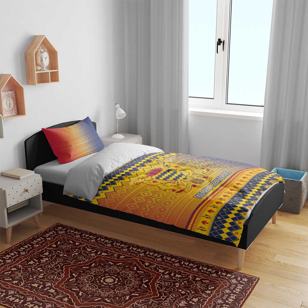 Christmas bedding set on bed with blue-yellow crest pattern and “Merry Christmas” text band