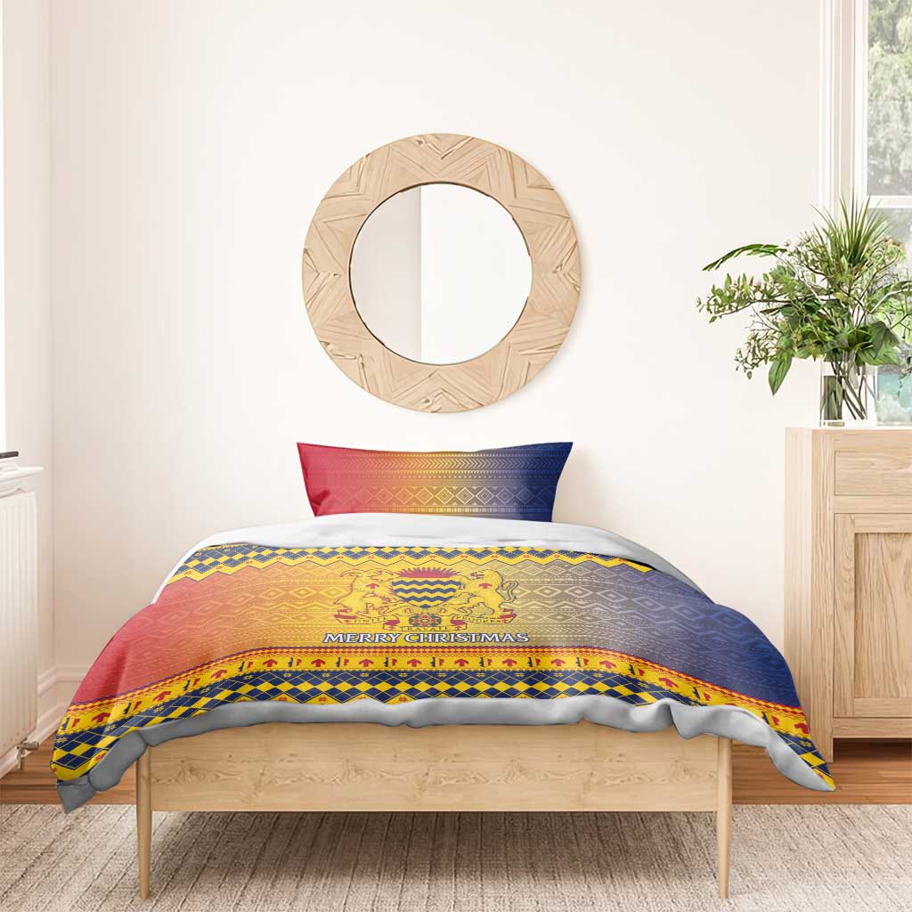 Christmas bedding set with blue and red crest design, “Merry Christmas” text, and matching pillows