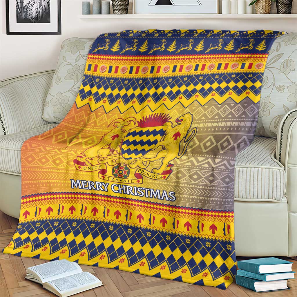 Christmas throw blanket draped on a couch, blue and gold crest with “Merry Christmas”