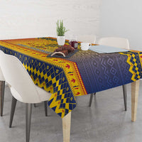 Blue and yellow geometric Christmas tablecloth draped over dining table