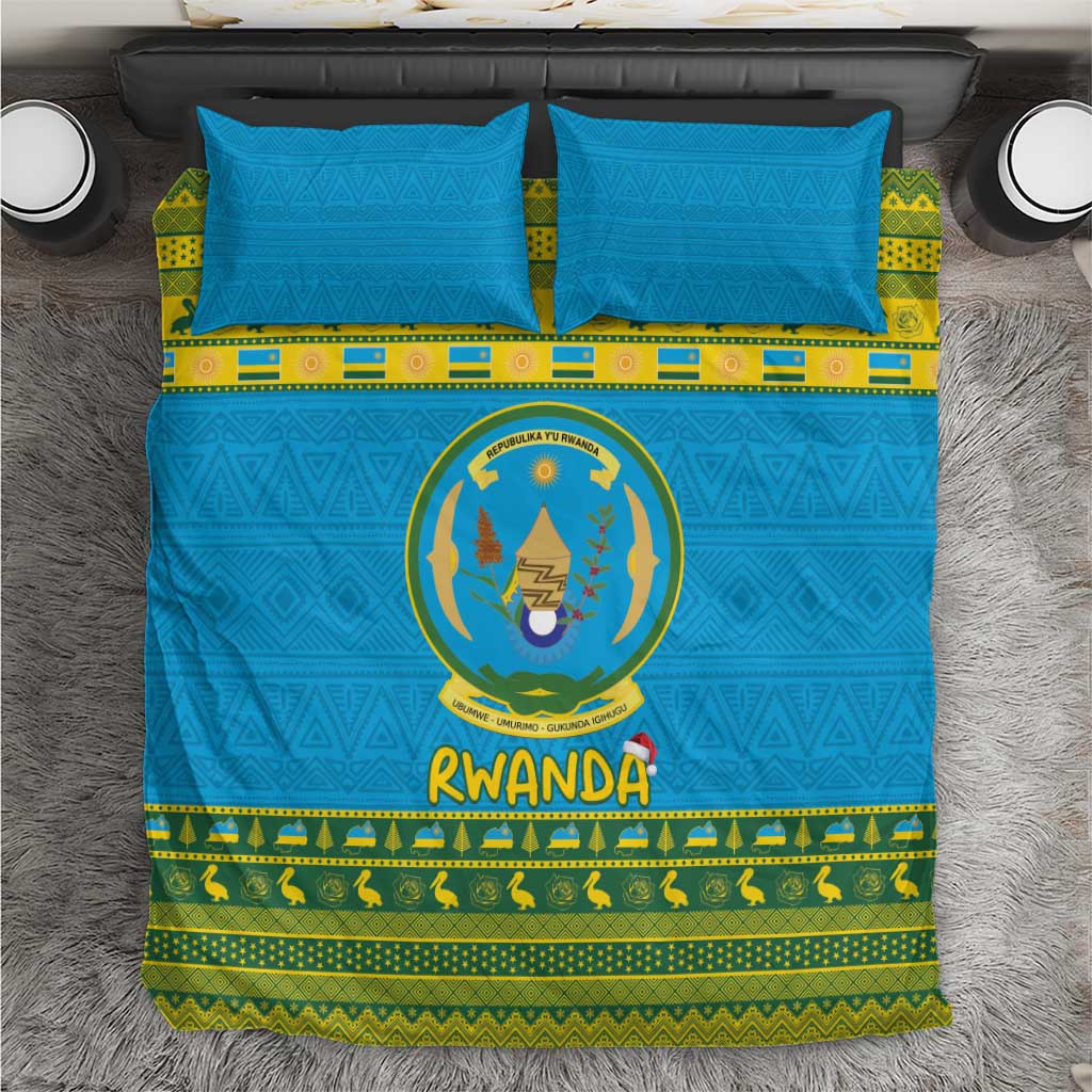 Blue Rwanda bedding set with emblem, green patterned border, and matching pillowcases