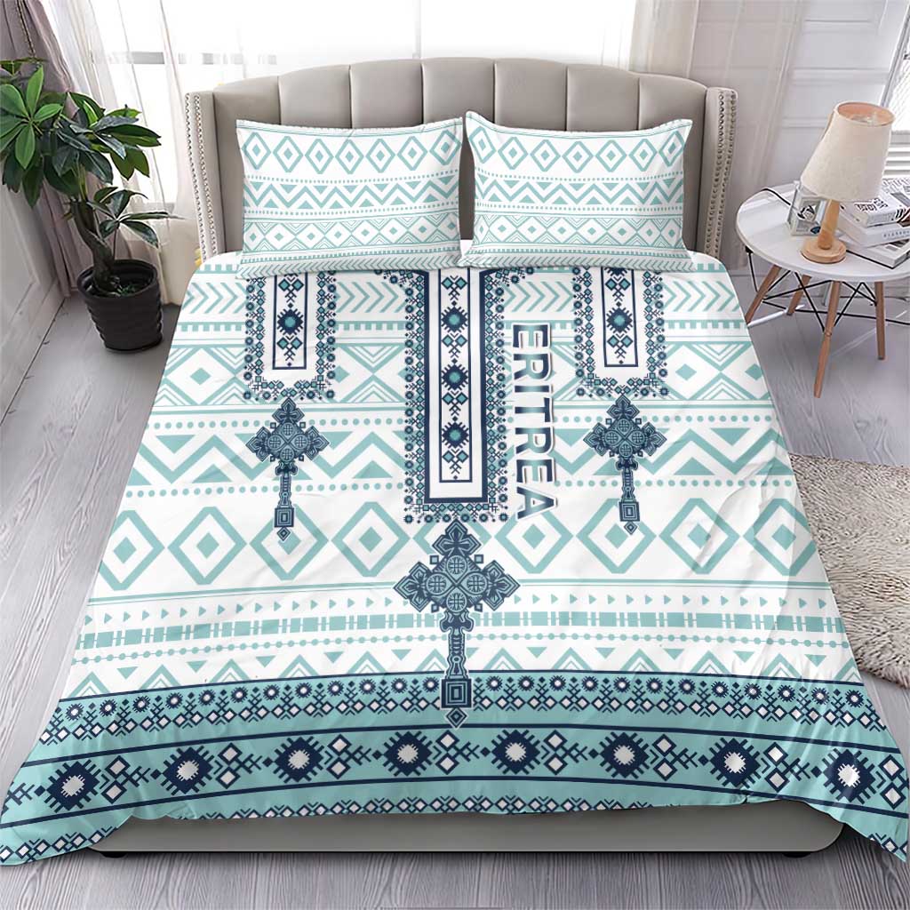 Teal/white patterned duvet cover with geometric cross motifs and two matching pillow shams
