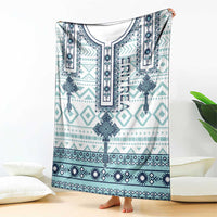 Folded geometric cross blanket, teal and navy patterned design with white border panel