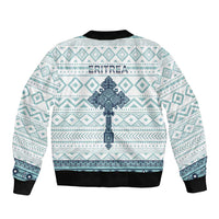 Unisex bomber jacket, back shows 'ERITREA' text and large cross motif, teal/white pattern