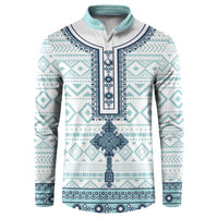 Teal and white patterned button sweatshirt with navy trim and long sleeves