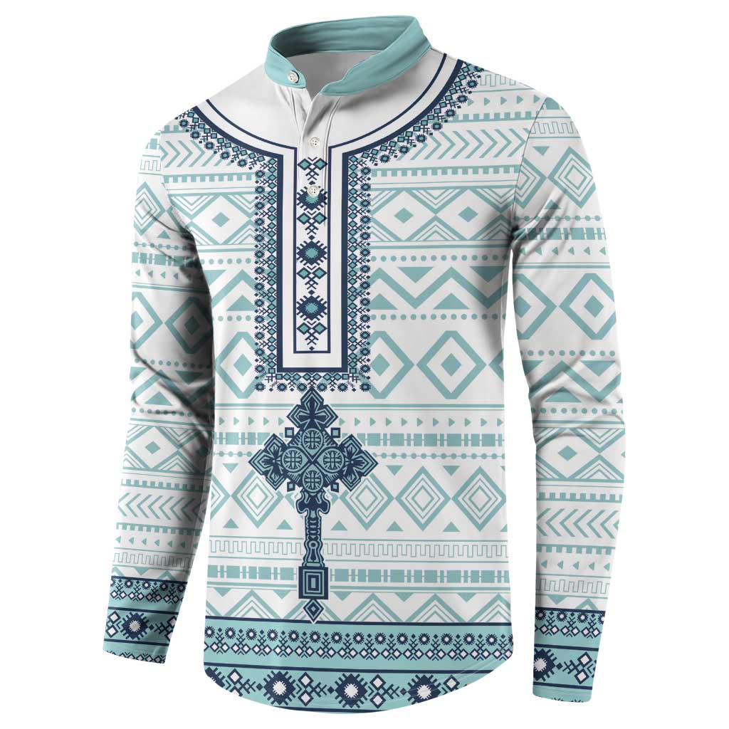 Teal, white, and navy patterned henley button sweatshirt with long sleeves