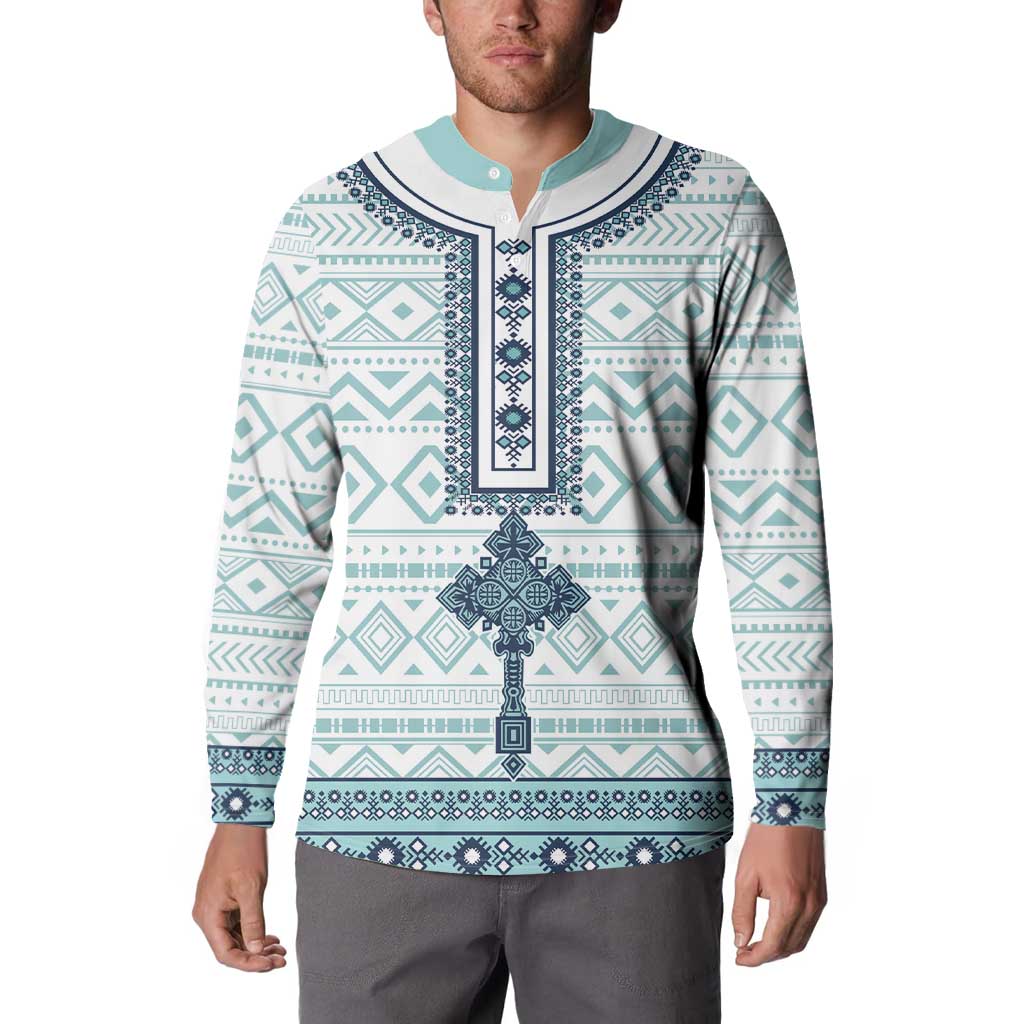Model wearing teal and white patterned button sweatshirt with navy trim