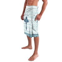Men's lavalava sarong with teal and white geometric cross tile pattern, side view
