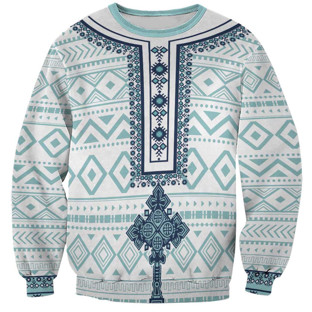 Unisex sweatshirt with teal tile pattern and dark cross graphic, crew neck, long sleeves