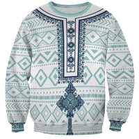 Unisex sweatshirt with teal tile pattern and dark cross graphic, crew neck, long sleeves