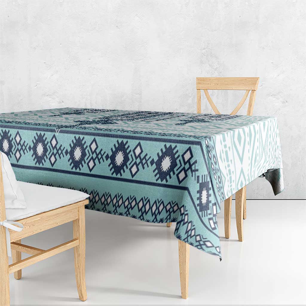 Teal and navy patterned tablecloth draped over a table with long edge corners