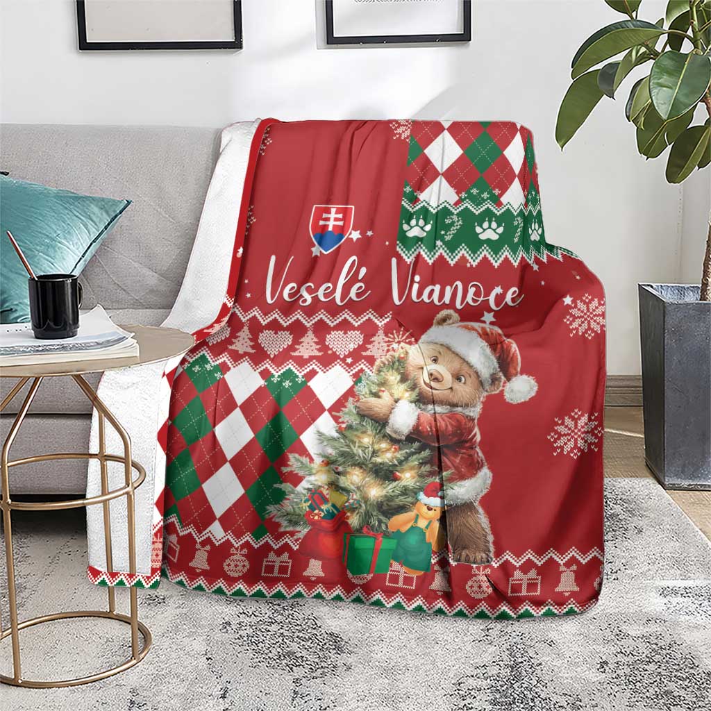 Red Christmas blanket draped over chair with bear character and green white argyle trim