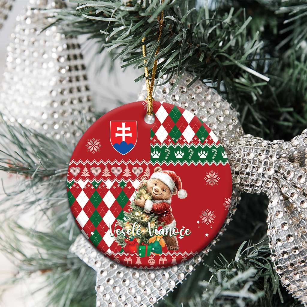 Red ceramic circular Christmas ornament with bear, argyle plaid pattern, Slovak shield, hanging