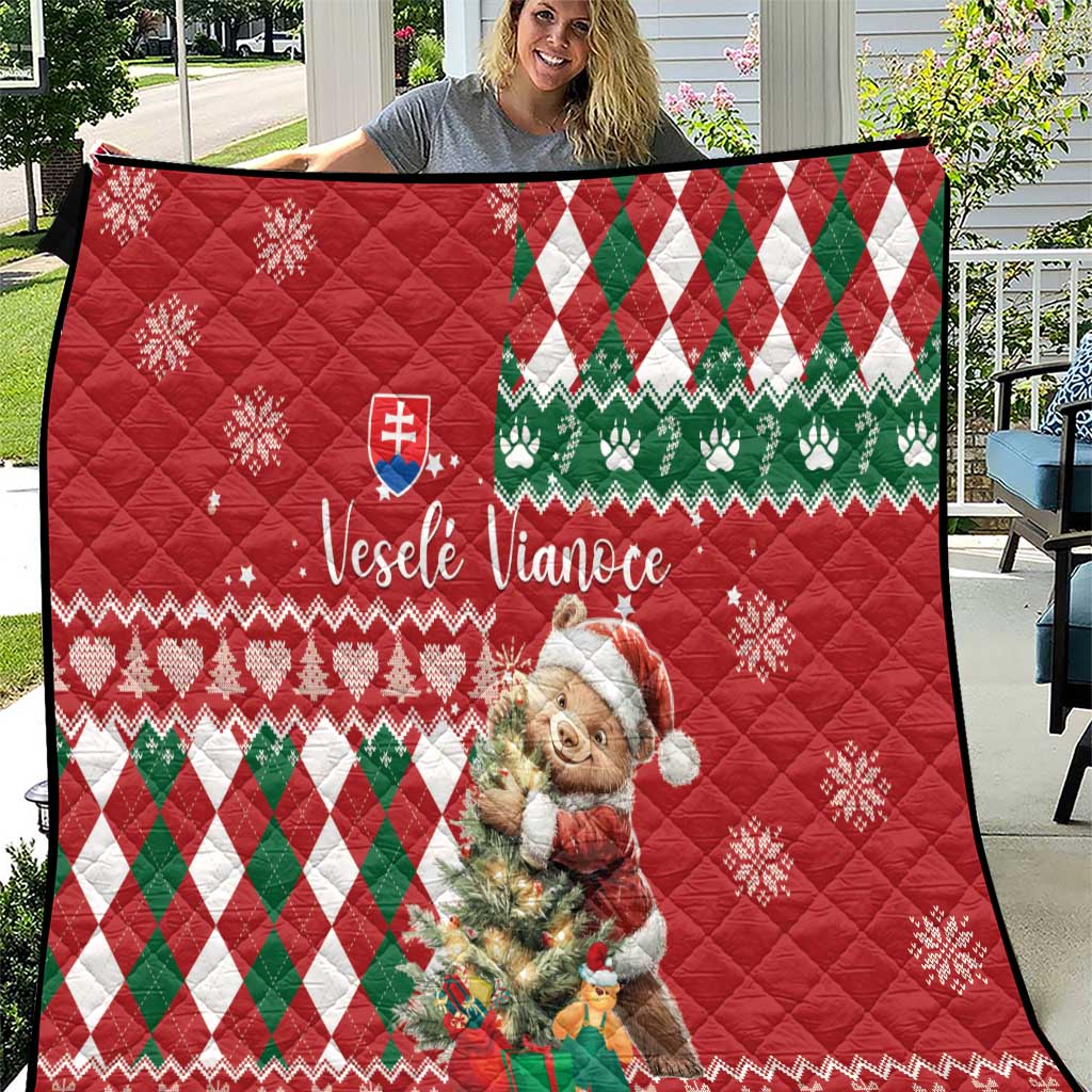 Red Christmas quilt with green-and-white argyle pattern, bear graphic, Slovak flag