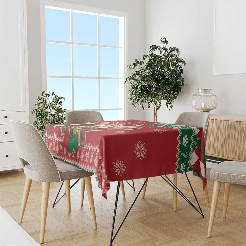Red tablecloth with geometric argyle border and snowflake motifs on dining table
