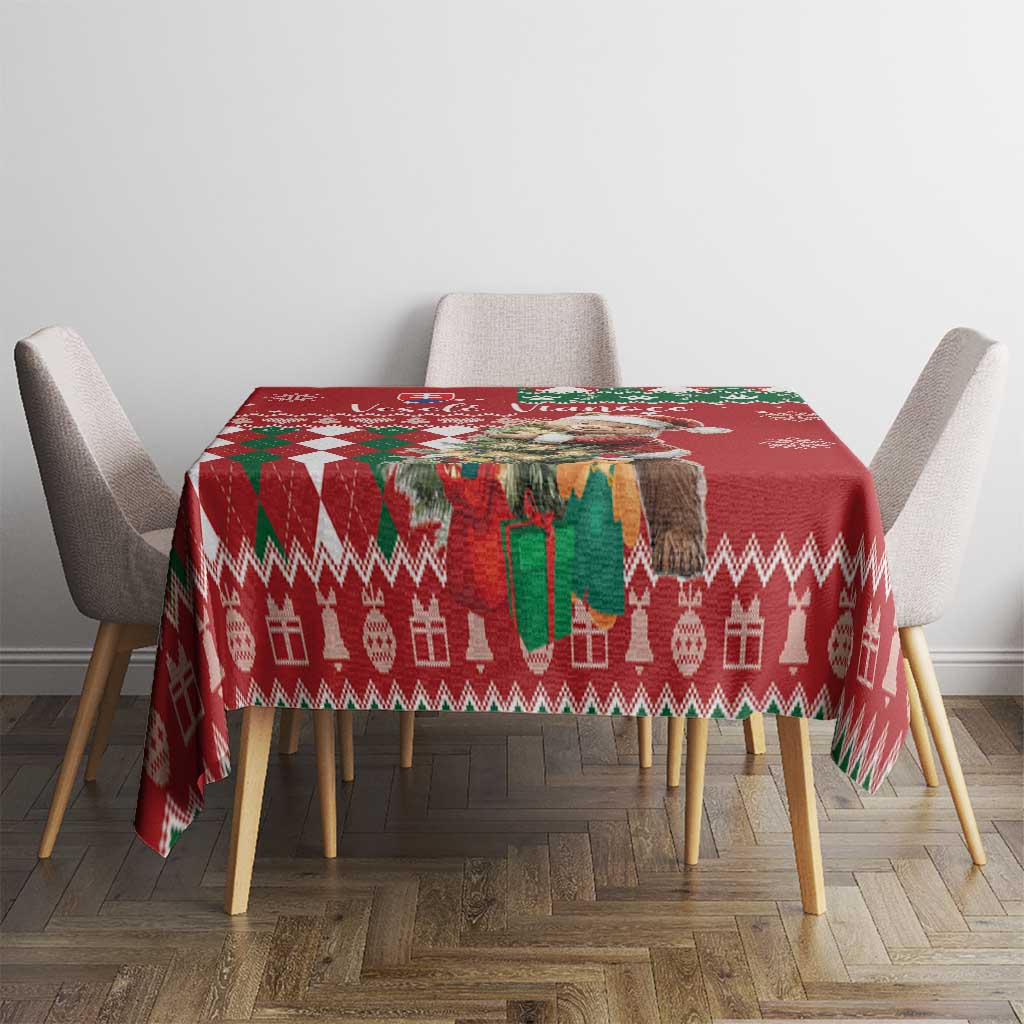Red holiday tablecloth with geometric border and repeating reindeer motifs