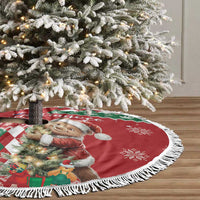 Red round Christmas tree skirt with white fringe, bear and snowy argyle design