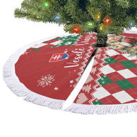 Red round Christmas tree skirt with white fringe, bear and argyle pattern, flat lay