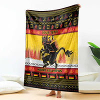 Yellow throw blanket with Krampus rider graphic, chain stripe and 'MERRY KRAMPUS' band