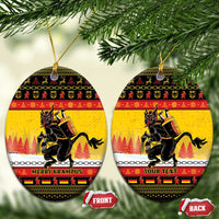Yellow oval ceramic Christmas ornament with Krampus artwork and gold hanging string.