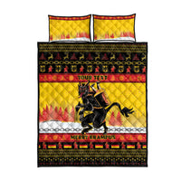 Yellow quilt bed set with two pillowcases, central Krampus artwork, and red trim